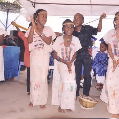 Pupils performing a traditional dance in matching outfits
